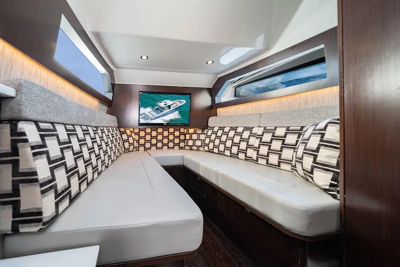 Slide: The Image of 2022 Pursuit S 428 Sport yacht docked near modern waterfront buildings. - 20