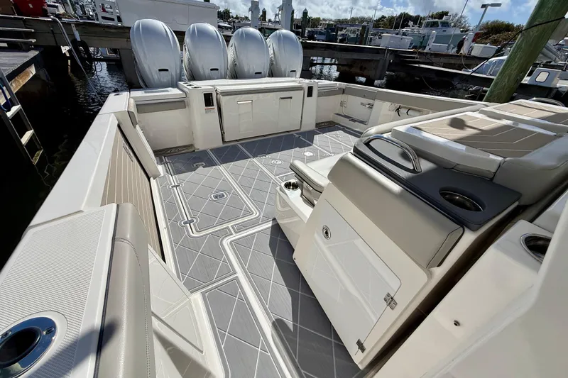Slide: The Image of 2022 Pursuit S 428 Sport boat interior with seating and outboard motors. - 26
