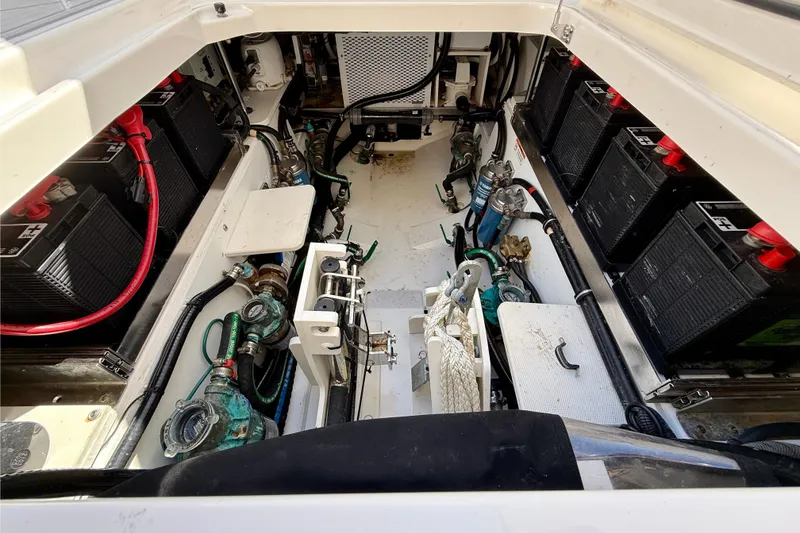 Slide: The Image of 2022 Pursuit S 428 Sport boat engine compartment with batteries and wiring. - 28