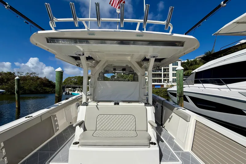 Slide: The Image of 2022 Pursuit S 428 Sport boat interior with seating, docked at marina. - 29