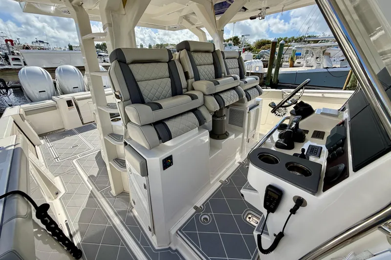 Slide: The Image of 2022 Pursuit S 428 Sport boat interior with luxurious seating and modern controls. - 39