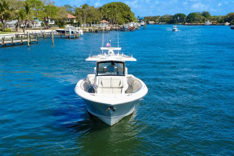 Slide: The Image of 2022 Pursuit S 428 Sport boat cruising on a scenic waterway. - 4