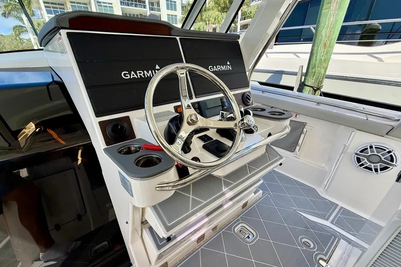 Slide: The Image of 2022 Pursuit S 428 Sport boat helm with Garmin navigation system and steering wheel. - 41