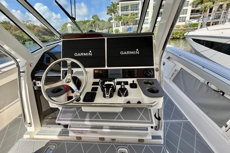 Slide: The Image of 2022 Pursuit S 428 Sport boat helm with Garmin displays and steering wheel. - 43