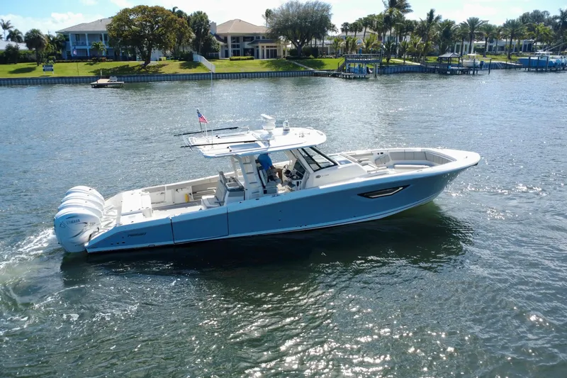 Slide: The Image of 2022 Pursuit S 428 Sport boat cruising on a sunny waterfront. - 5