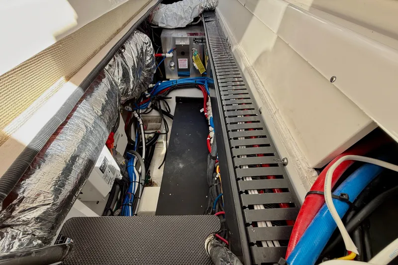 Slide: The Image of Engine compartment of 2022 Pursuit S 428 Sport boat with wiring and insulation. - 53
