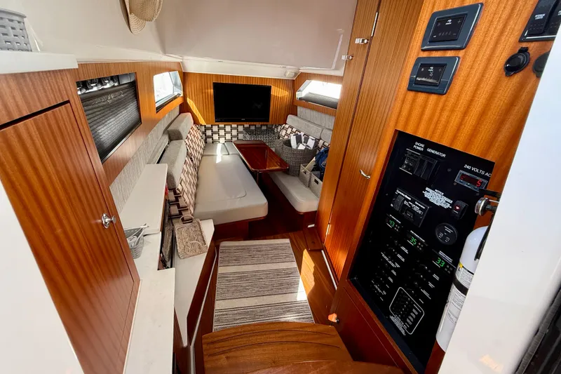 Slide: The Image of Luxurious interior of 2022 Pursuit S 428 Sport boat with wood paneling and seating area. - 54