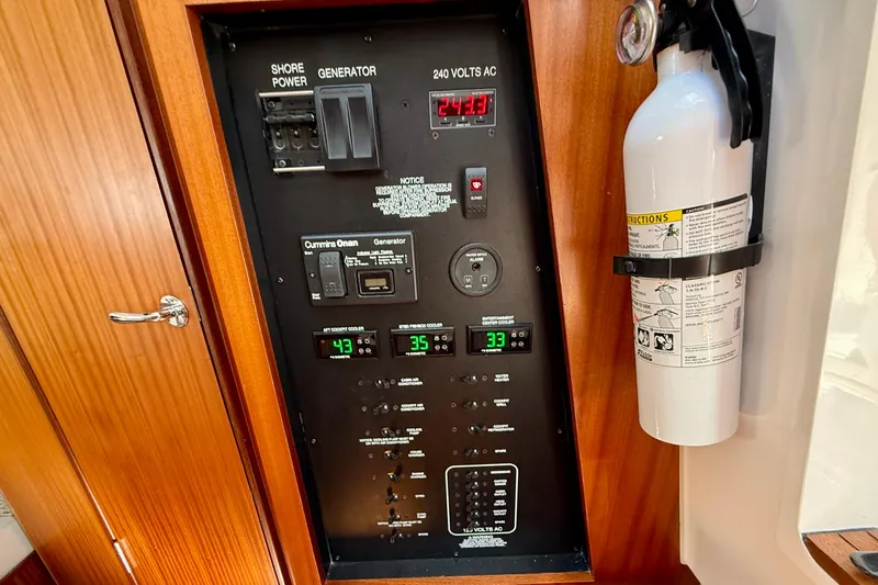 Slide: The Image of Electrical panel and fire extinguisher on 2022 Pursuit S 428 Sport boat. - 58
