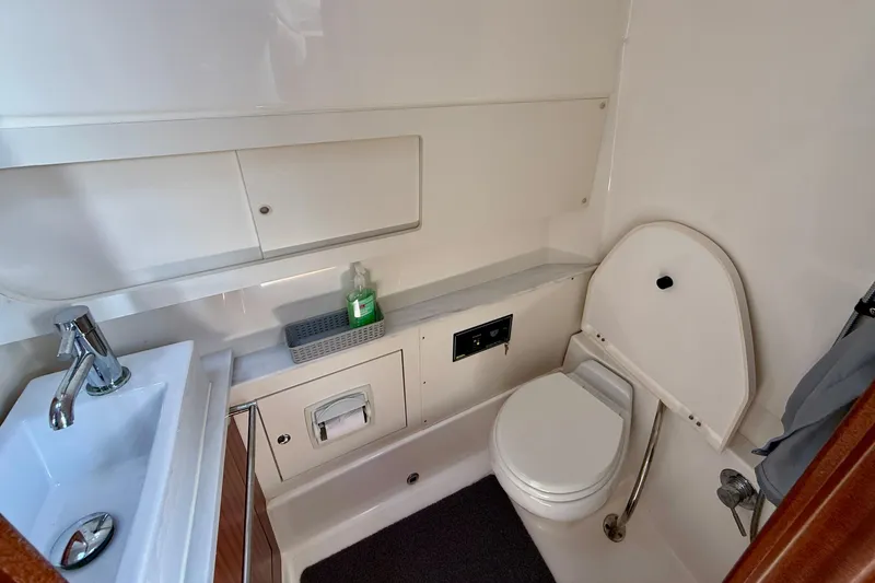Slide: The Image of 2022 Pursuit S 428 Sport boat bathroom with sink, toilet, and storage. - 59