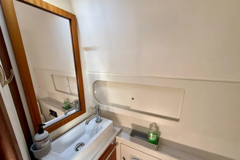 Slide: The Image of 2022 Pursuit S 428 Sport boat bathroom with sink, mirror, and storage. - 60