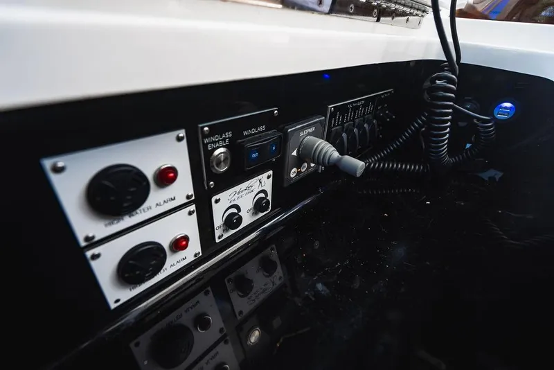 Slide: The Image of Control panel of 2023 Valhalla Boatworks V-46, featuring switches and dials. - 19