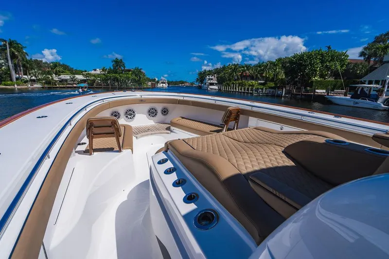 Slide: The Image of 2023 Valhalla Boatworks V-46 luxury boat interior with plush seating and scenic waterway view. - 20