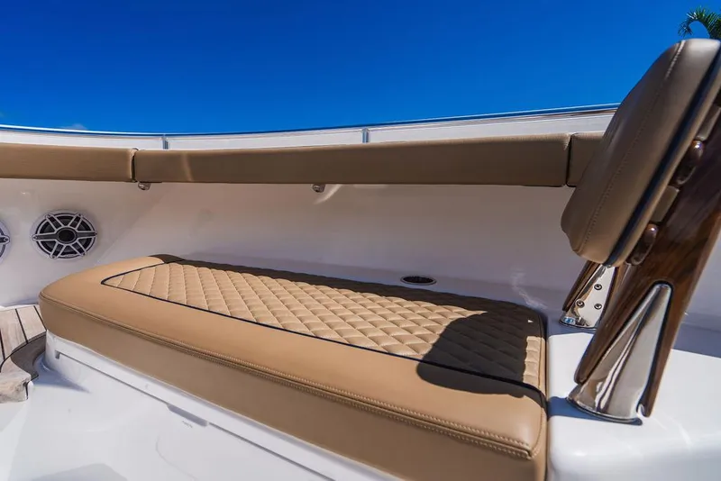 Slide: The Image of 2023 Valhalla Boatworks V-46 interior with tan seating and blue sky background. - 21
