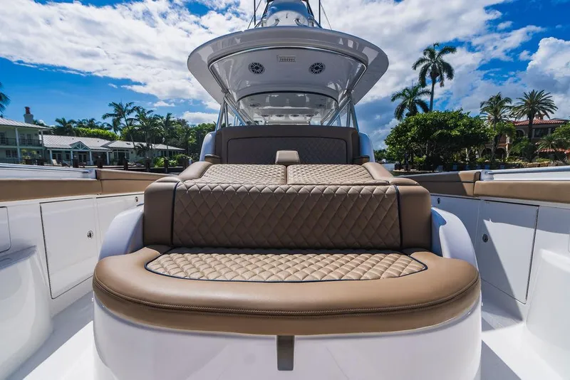 Slide: The Image of 2023 Valhalla Boatworks V-46 luxury seating with quilted upholstery under a sunny sky. - 27