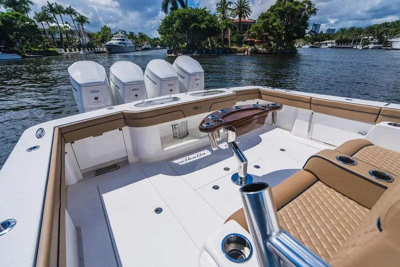 Slide: The Image of 2023 Valhalla Boatworks V-46 with luxurious seating and powerful engines on a scenic waterway. - 30