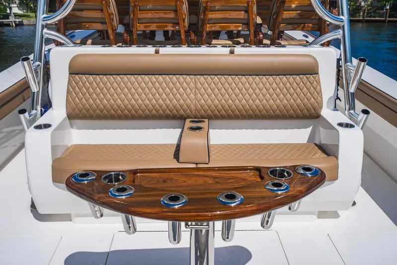 Slide: The Image of 2023 Valhalla Boatworks V-46 interior with tan quilted seating and wooden rod holders. - 35