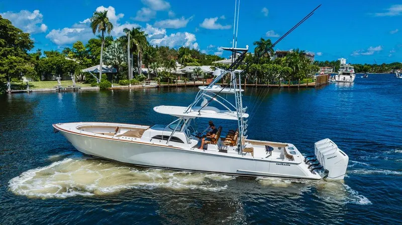 Slide: The Image of 2023 Valhalla Boatworks V-46 cruising on a scenic waterway with lush greenery. - 4