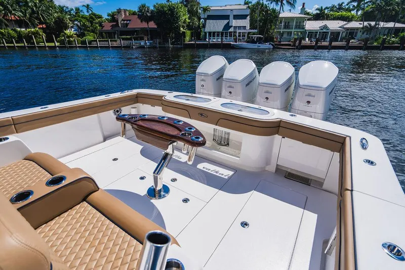 Slide: The Image of 2023 Valhalla Boatworks V-46 with quad engines, luxurious seating, and sleek design on a sunny waterfront. - 47