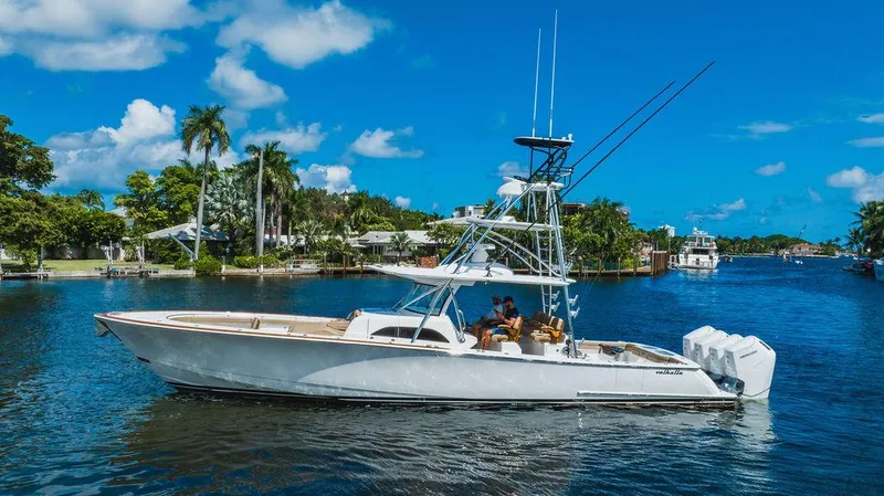 Slide: The Image of 2023 Valhalla Boatworks V-46 cruising on a sunny day, surrounded by lush greenery. - 5