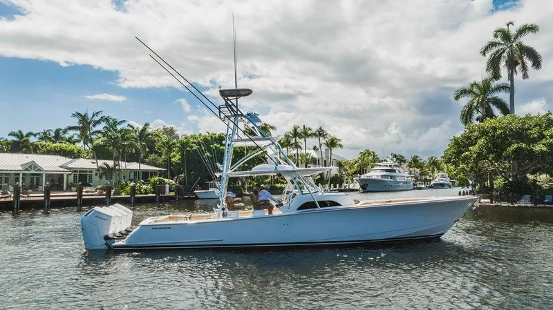 Slide: The Image of 2023 Valhalla Boatworks V-46 cruising on a scenic waterway with palm trees. - 7