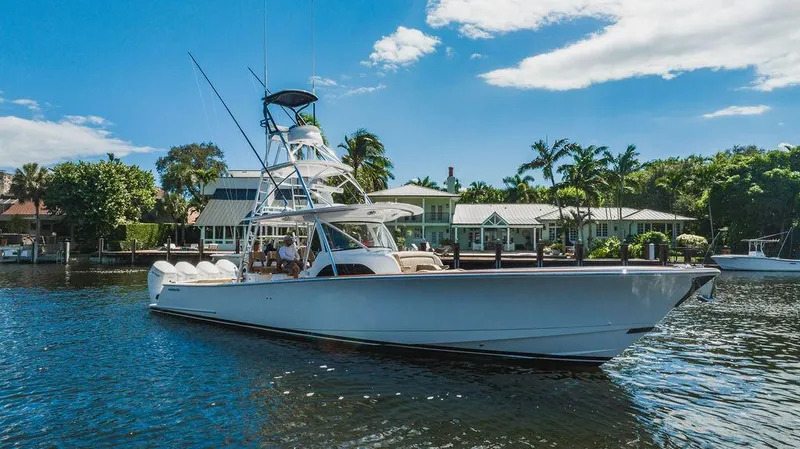 Slide: The Image of 2023 Valhalla Boatworks V-46 yacht cruising on a sunny day near waterfront homes. - 8