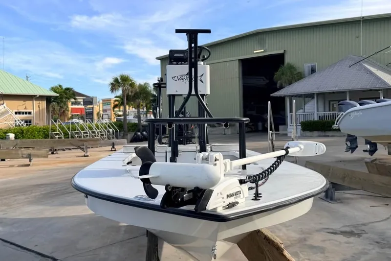 Slide: The Image of 2014 East Cape Vantage VHP boat with Minn Kota motor in marina setting. - 11