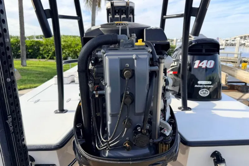 Slide: The Image of 2014 East Cape Vantage VHP boat engine, docked with palm trees in the background. - 17