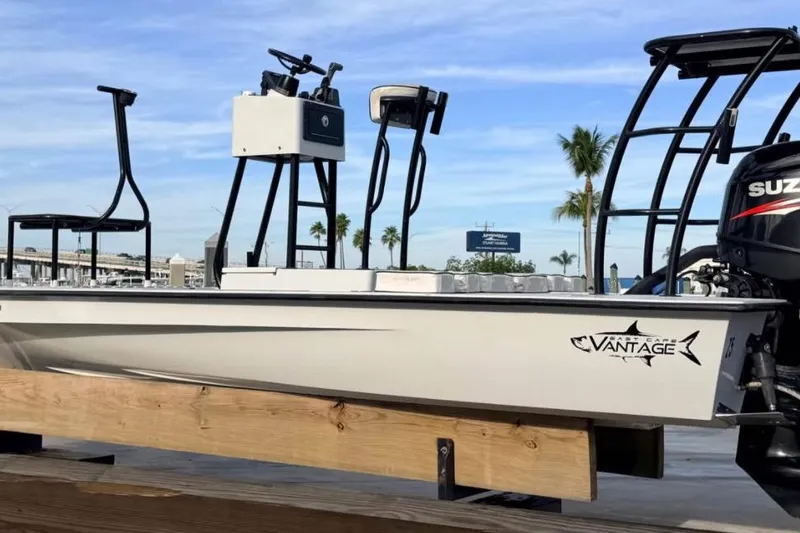 Slide: The Image of 2014 East Cape Vantage VHP boat with Suzuki engine, docked under clear skies. - 3