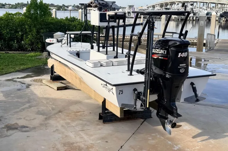 Slide: The Image of 2014 East Cape Vantage VHP boat with Suzuki 140 engine at a marina dock. - 4