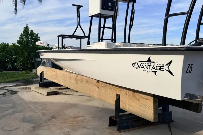 Slide: The Image of 2014 East Cape Vantage VHP boat on a wooden stand, outdoors. - 6