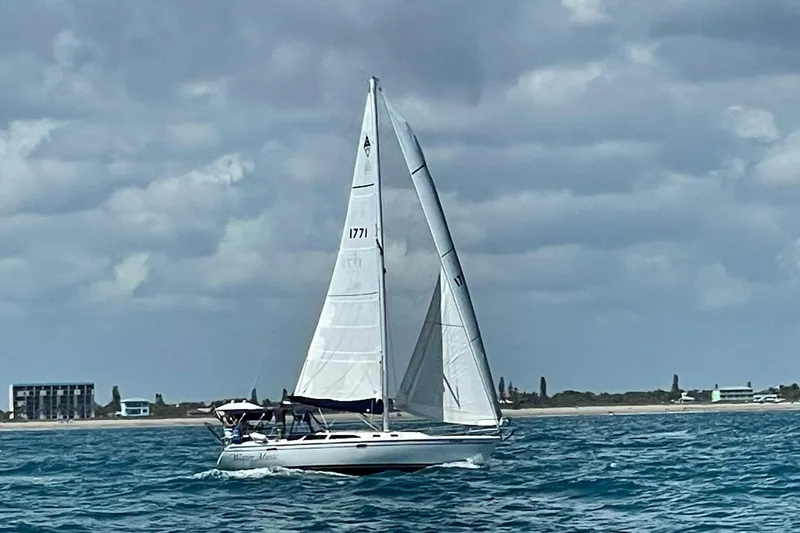 The Image of Sailboat Catalina 36 MkII 1999 cruising on open water under cloudy skies. - 0