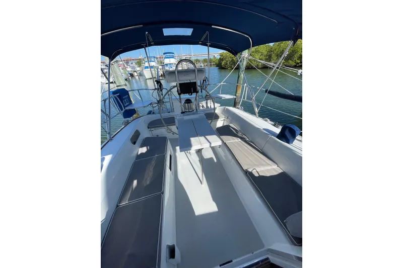 Slide: The Image of 1999 Catalina 36 MkII sailboat cockpit with seating and helm, docked in marina. - 11