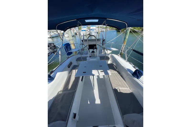 Slide: The Image of 1999 Catalina 36 MkII sailboat cockpit with seating and helm, docked in marina. - 13