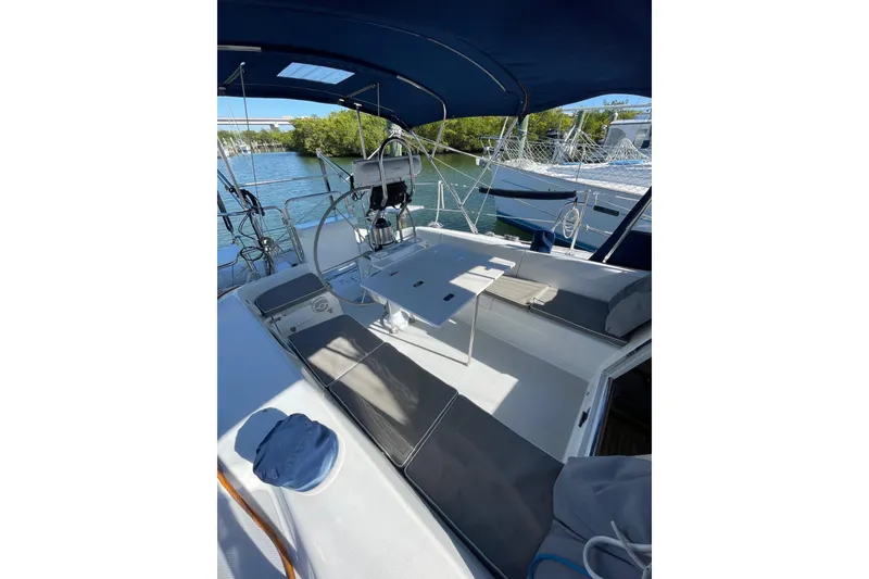 Slide: The Image of 1999 Catalina 36 MkII sailboat cockpit with seating, table, and canopy on a sunny day. - 14