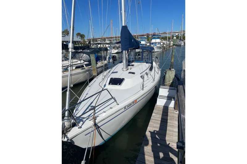 Slide: The Image of 1999 Catalina 36 MkII sailboat docked at marina under clear blue sky. - 2