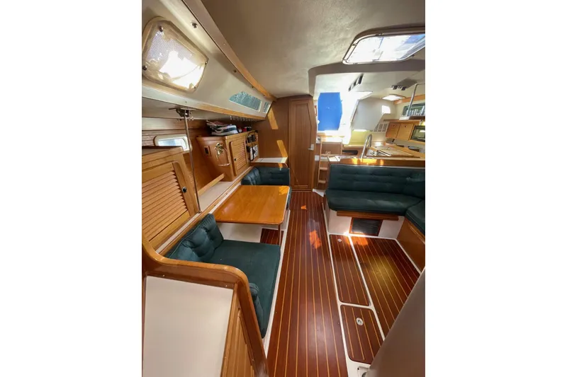 Slide: The Image of Interior of 1999 Catalina 36 MkII sailboat with wood finish and green seating. - 23