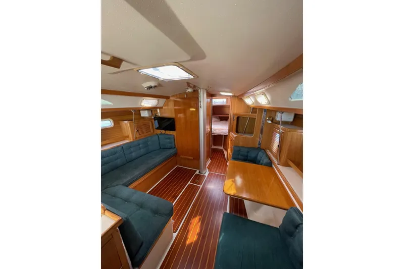 Slide: The Image of Interior of 1999 Catalina 36 MkII sailboat with wood finish and blue seating. - 26