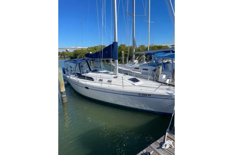 Slide: The Image of 1999 Catalina 36 MkII sailboat docked in a marina under clear blue skies. - 3