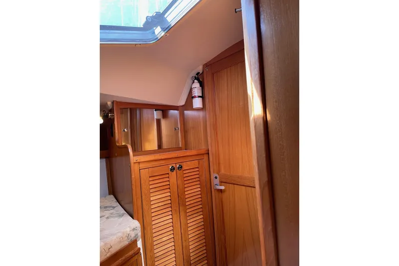 Slide: The Image of Interior of 1999 Catalina 36 MkII sailboat with wooden cabinetry and fire extinguisher. - 32