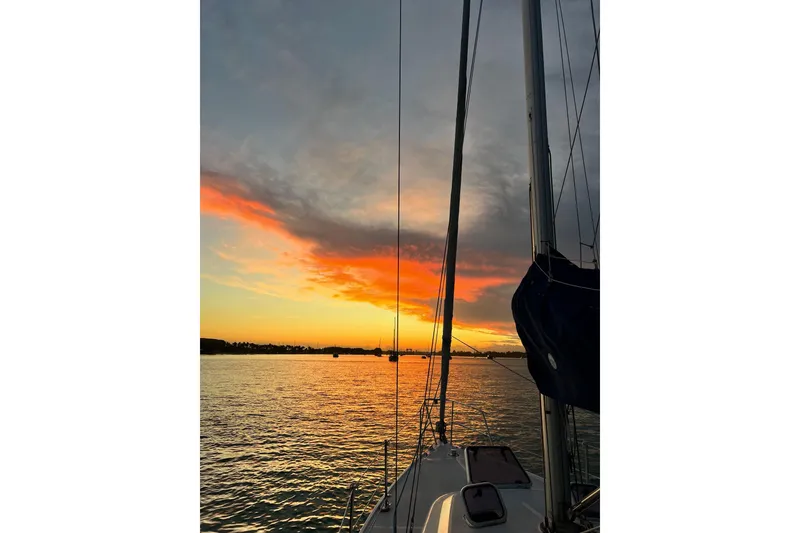 Slide: The Image of Sailboat Catalina 36 MkII at sunset, 1999 model, on tranquil water with vibrant sky. - 38