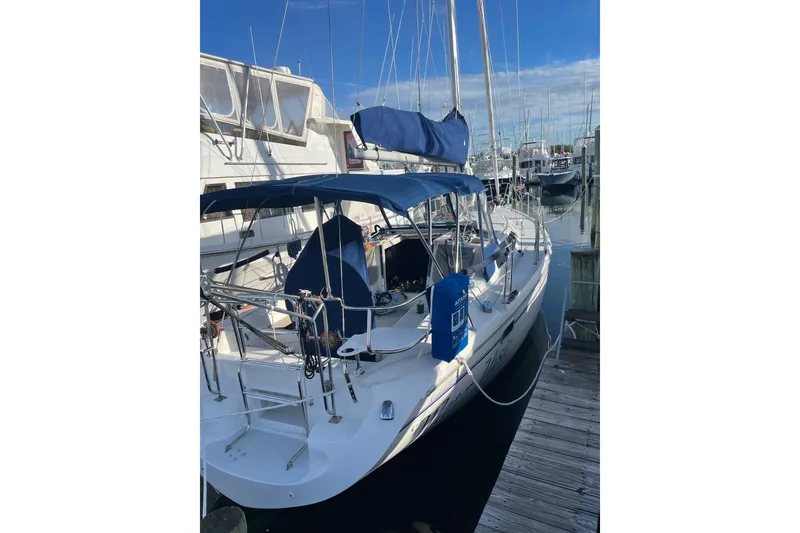 Slide: The Image of 1999 Catalina 36 MkII sailboat docked at marina, featuring blue canvas covers. - 4