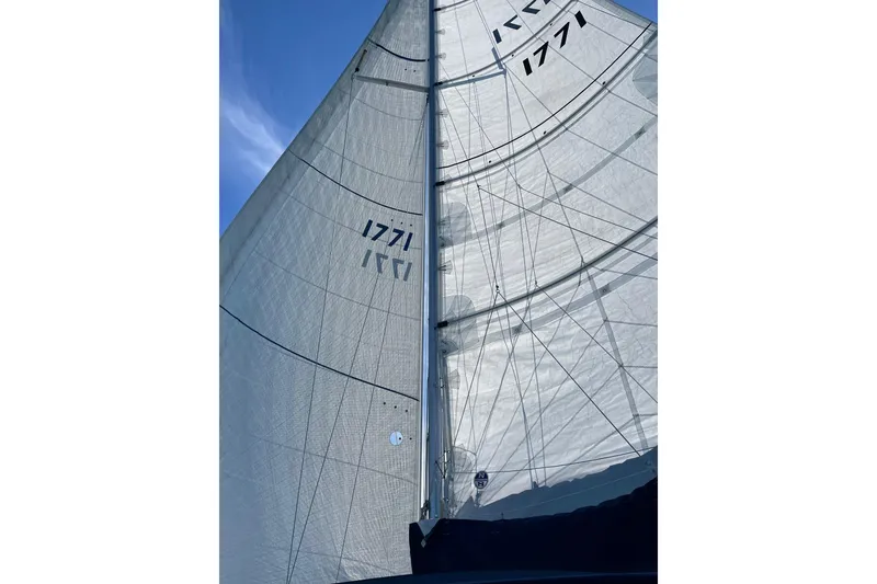 Slide: The Image of Sail of a 1999 Catalina 36 MkII yacht against a clear blue sky. - 9