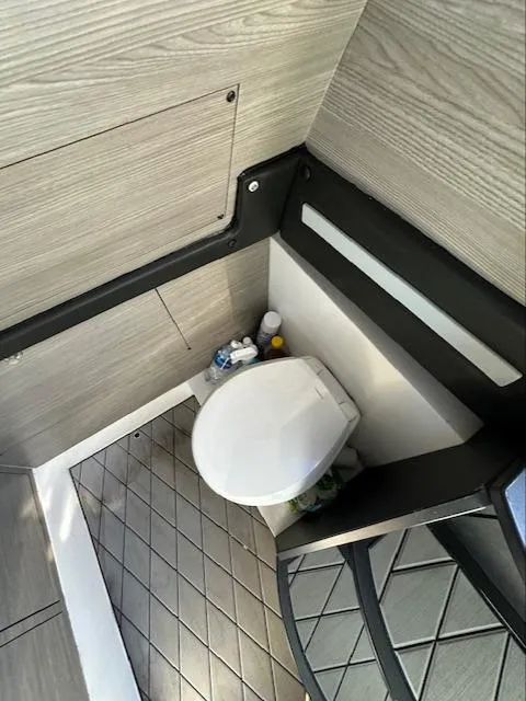 Slide: The Image of 2019 Mystic Powerboats M4200 interior bathroom with modern design and compact toilet. - 22