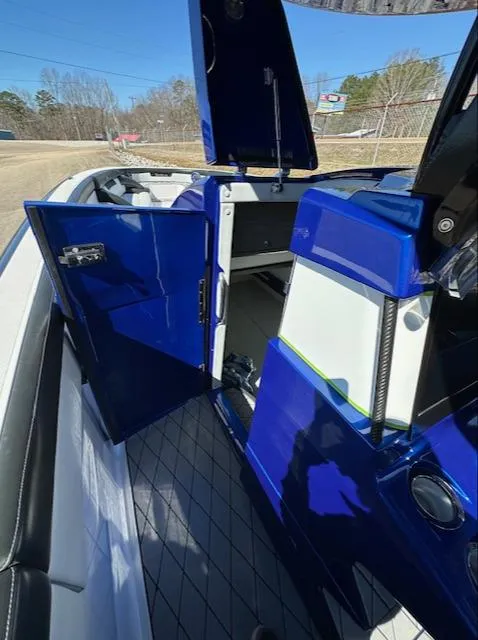 Slide: The Image of 2019 Mystic Powerboats M4200 interior with open blue cabin door, showcasing sleek design. - 25