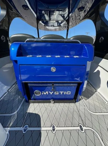 Slide: The Image of 2019 Mystic Powerboats M4200 interior with blue console and seating. - 6