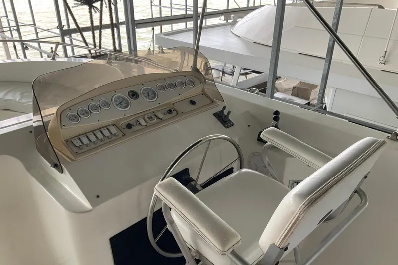 Slide: The Image of Cockpit of 2004 Sumerset 18 x 87 houseboat with steering wheel and control panel. - 14