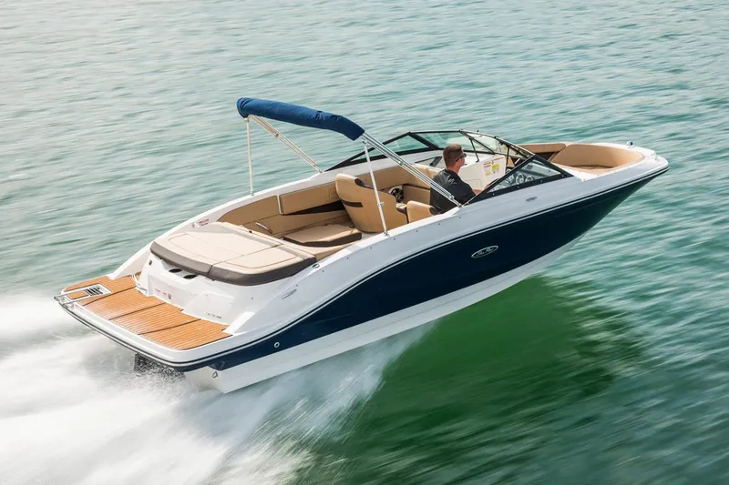 The Image of 2021 Sea Ray SPX 210 boat on trailer, parked outdoors with trees in background. - 0