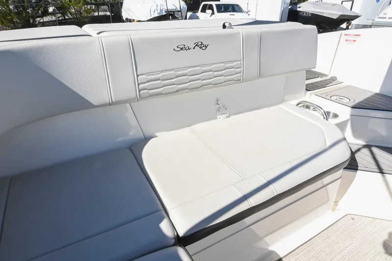 Slide: The Image of 2021 Sea Ray SPX 210 boat interior with white cushioned seating. - 17