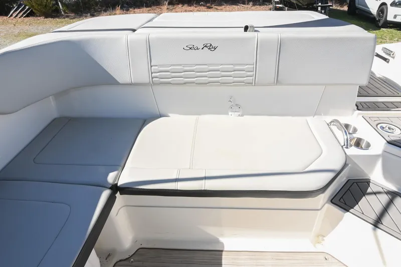 Slide: The Image of 2021 Sea Ray SPX 210 boat interior with white cushioned seating. - 18