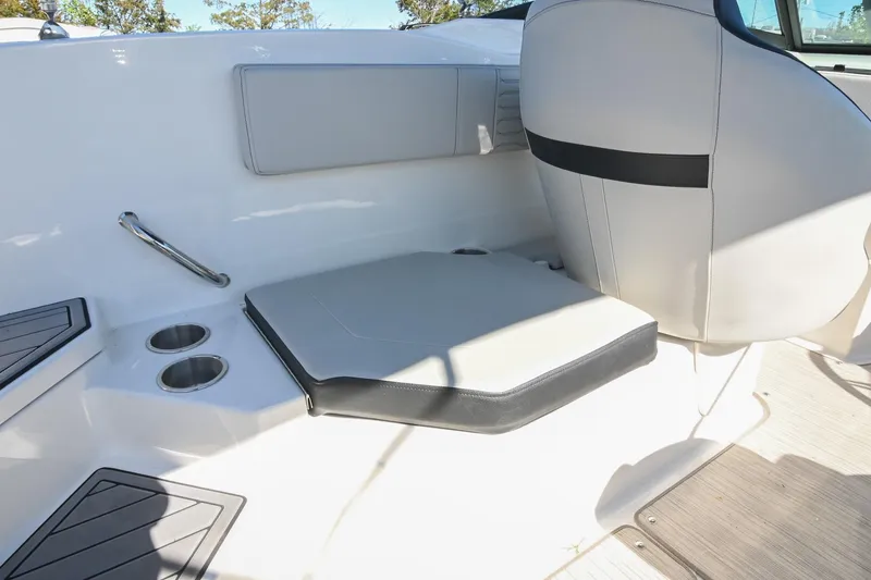 Slide: The Image of Interior seating of 2021 Sea Ray SPX 210 boat with cup holders and cushion. - 19